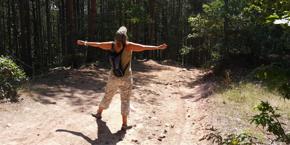 A person hiking, enjoying the mental health benefits of nature.