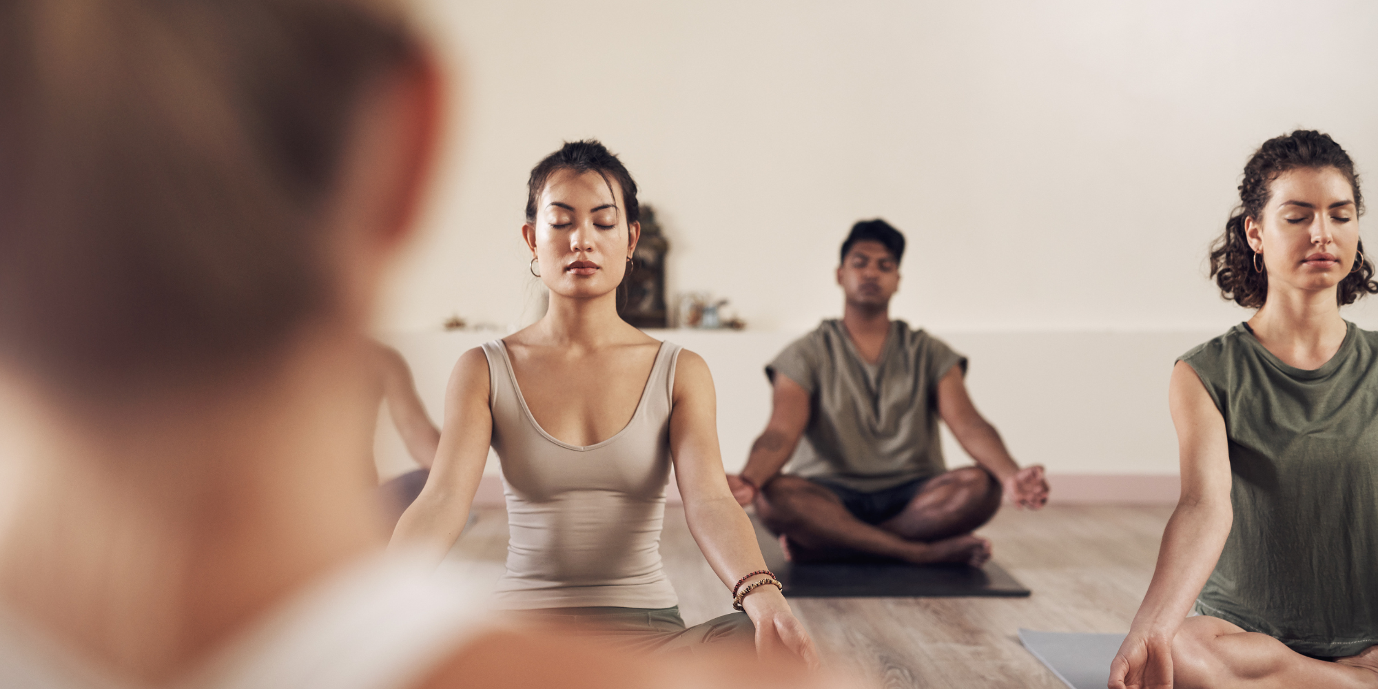 A yoga class in session. Yoga is one of the examples of how to manage stress in a healthy way.