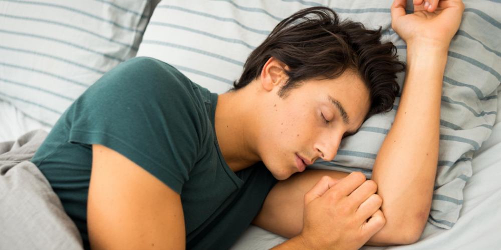 A man sleeping peacefully, demonstrating how tips for improving your sleep can help.