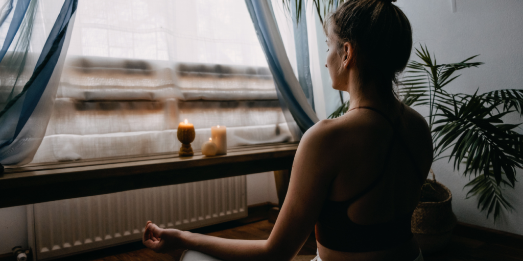 A woman meditating, to cope with stress.