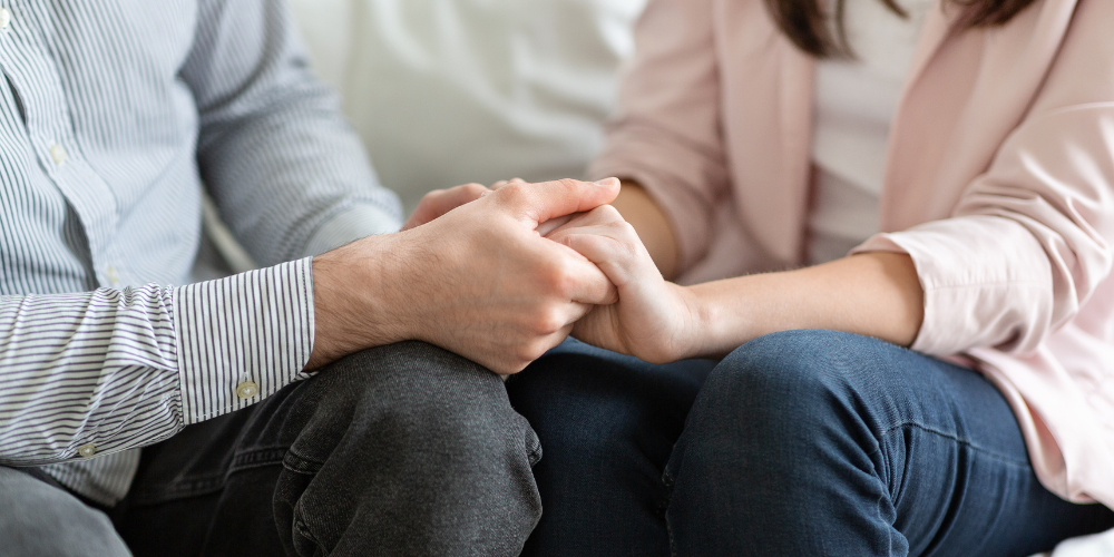 A couple holding hands, symbolizing codependency.