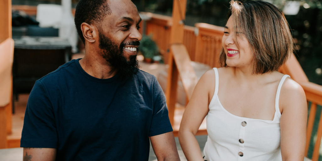 A man and a woman talking and smiling.