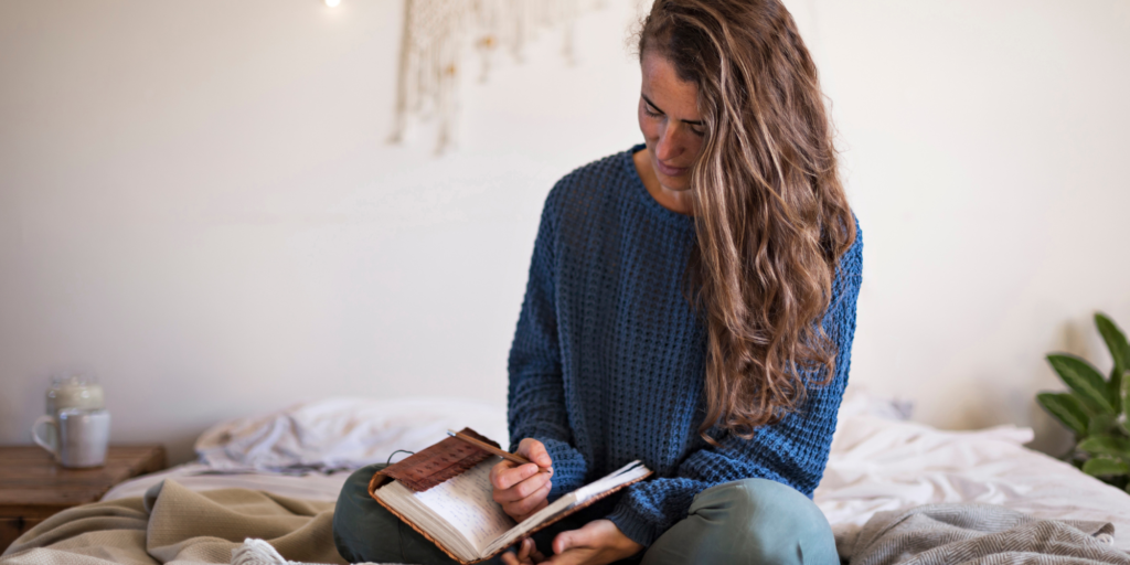 A woman journaling in her home.