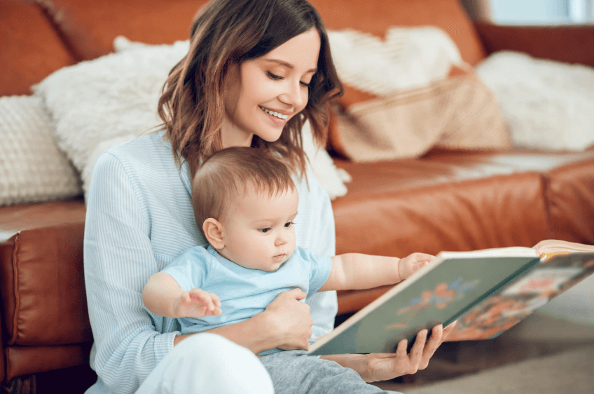 Mom reading a book to baby.